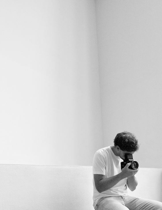 An image of Nicolas Llasera taking a picture with a Mamiya 645 Super in black and white